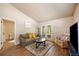 Bright living room with high ceilings, wood floors, and cozy furniture at 6175 Beechwood Dr, Dade City, FL 33523