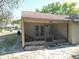 Enclosed screened patio with an exterior door, providing a comfortable outdoor living space at 6175 Beechwood Dr, Dade City, FL 33523