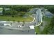 Panoramic aerial view showcasing the community with lush landscaping, scenic pond, and well-maintained streets at 17677 Nectar Flume Dr, Land O Lakes, FL 34637