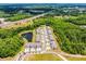 An aerial view features new townhomes alongside lush green trees, a pond, and easy access to the highway at 17677 Nectar Flume Dr, Land O Lakes, FL 34637