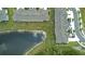 Aerial view showcasing the home community's tranquil pond and convenient parking area at 17677 Nectar Flume Dr, Land O Lakes, FL 34637