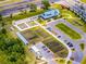Stunning aerial view of a community farm with garden plots, parking, and a charming blue-roofed building next to a highway at 17677 Nectar Flume Dr, Land O Lakes, FL 34637