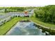 An aerial view of the community showcasing the surrounding greenspace and a pond that reflects the sky at 17677 Nectar Flume Dr, Land O Lakes, FL 34637