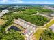 Aerial view of the community featuring ponds, trees, and modern townhome-style homes at 17677 Nectar Flume Dr, Land O Lakes, FL 34637