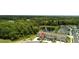 Aerial view of townhomes overlooking community pond with lush landscaping and parking at 17677 Nectar Flume Dr, Land O Lakes, FL 34637