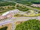 Aerial view of the community showing the layout of buildings, roadways, landscaping, and parking areas at 17677 Nectar Flume Dr, Land O Lakes, FL 34637