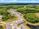 An aerial view of a new construction community with well-maintained landscaping and serene ponds at 17677 Nectar Flume Dr, Land O Lakes, FL 34637