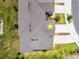 Aerial view of a home with a gray roof, lawn, and multi-car driveway at 17677 Nectar Flume Dr, Land O Lakes, FL 34637