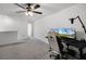 Versatile bonus room with carpet flooring, ceiling fan, and a dedicated workstation setup for productivity and comfort at 17677 Nectar Flume Dr, Land O Lakes, FL 34637