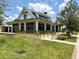 Exterior shot of the community center with brick sidewalk, landscaping, and white pillars at 17677 Nectar Flume Dr, Land O Lakes, FL 34637