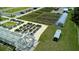 Aerial view of a sprawling community garden with raised beds, greenhouses, and ample parking at 17677 Nectar Flume Dr, Land O Lakes, FL 34637