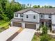 Beautiful townhome exterior with stone accents, two car garage and well-kept landscaping at 17677 Nectar Flume Dr, Land O Lakes, FL 34637