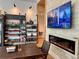 Interior view of the market with a display shelf of produce and a wall-mounted TV above a fireplace at 17677 Nectar Flume Dr, Land O Lakes, FL 34637