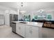 Bright kitchen featuring stainless steel appliances, white cabinetry, and a center island with a sink at 17677 Nectar Flume Dr, Land O Lakes, FL 34637