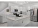 Bright, modern kitchen featuring white cabinets, stainless steel appliances, and a center island at 17677 Nectar Flume Dr, Land O Lakes, FL 34637