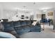 Open concept living room with a large couch, adjacent to dining area and kitchen at 17677 Nectar Flume Dr, Land O Lakes, FL 34637
