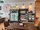 Interior view of the market showcasing the shelving with produce and cafe seating with a wooden table at 17677 Nectar Flume Dr, Land O Lakes, FL 34637