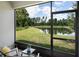 View from screened patio looking out over pond, mature trees and landscaping at 17677 Nectar Flume Dr, Land O Lakes, FL 34637