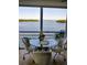 Lovely dining area with a glass table and chairs, offering picturesque views of the bay through large windows at 4310 Falmouth Dr # 301, Longboat Key, FL 34228