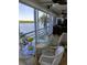 Bright dining area featuring a glass table and chairs with expansive windows offering stunning waterfront views at 4310 Falmouth Dr # 301, Longboat Key, FL 34228