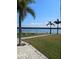 Tranquil grounds with manicured lawn, pavers, palm trees, and water views at 4310 Falmouth Dr # 301, Longboat Key, FL 34228