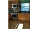 Well-equipped kitchen with stainless steel appliances, granite countertops, and wooden cabinetry at 4310 Falmouth Dr # 301, Longboat Key, FL 34228