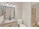 Well-lit bathroom with a decorative mirror, vanity sink, and a convenient walk-in shower at 4804 Myrtle Oak Dr # 11, New Port Richey, FL 34653