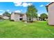 Exterior view of building featuring lawn, patios, landscaping, and nearby buildings at 4804 Myrtle Oak Dr # 11, New Port Richey, FL 34653