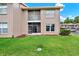 Exterior view of building featuring lawn, patio, windows, and landscaping at 4804 Myrtle Oak Dr # 11, New Port Richey, FL 34653