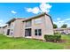 Exterior view of building with screened balcony, manicured lawn and landscaping at 4804 Myrtle Oak Dr # 11, New Port Richey, FL 34653
