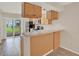 Efficient kitchen featuring wood cabinetry, stainless steel appliances, and a breakfast bar area at 4804 Myrtle Oak Dr # 11, New Port Richey, FL 34653