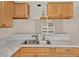 Kitchen with double sink, marble countertops, and ample cabinet space at 4804 Myrtle Oak Dr # 11, New Port Richey, FL 34653