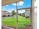 Enjoy the green lawn and surrounding community buildings from this screened patio view at 4804 Myrtle Oak Dr # 11, New Port Richey, FL 34653