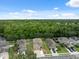 Aerial view of home in a neighborhood with mature trees and natural backdrop at 12534 Chenwood Ave, Hudson, FL 34669
