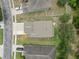 Overhead aerial view of home with a large driveway, lawn, and mature landscaping at 12534 Chenwood Ave, Hudson, FL 34669