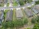An aerial photograph shows a home with well-manicured lawn with tree line, neighboring houses, and surrounding streets at 12534 Chenwood Ave, Hudson, FL 34669