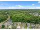 Beautiful aerial view of homes backing to a mature tree line and community pond on a sunny day at 12534 Chenwood Ave, Hudson, FL 34669