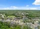 Aerial photograph of houses bordering pond with mature trees, capturing community charm on a bright day at 12534 Chenwood Ave, Hudson, FL 34669
