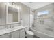 Stylish bathroom featuring tub, shower, and white marble vanity at 12534 Chenwood Ave, Hudson, FL 34669
