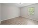 A light and airy bedroom with hard surface floors and a window at 12534 Chenwood Ave, Hudson, FL 34669