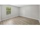 A well lit bedroom with hard surface floors and neutral colors at 12534 Chenwood Ave, Hudson, FL 34669