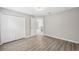 A bright bedroom with wood look floors and an adjacent closet at 12534 Chenwood Ave, Hudson, FL 34669