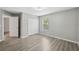 A bedroom offering an attached closet and wood look floors at 12534 Chenwood Ave, Hudson, FL 34669