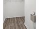 Walk-in closet with wood-look floors and white wire shelving for optimal storage at 12534 Chenwood Ave, Hudson, FL 34669