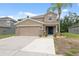 Charming two-story home with a well-manicured lawn and inviting front entrance at 12534 Chenwood Ave, Hudson, FL 34669