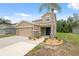 Charming two-story home with attached two car garage, and manicured flower beds at 12534 Chenwood Ave, Hudson, FL 34669