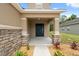 Charming front entrance with stone accents and a well-manicured walkway leading to the front door at 12534 Chenwood Ave, Hudson, FL 34669