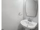 Bathroom features a pedestal sink and a large mirror at 12534 Chenwood Ave, Hudson, FL 34669