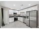 Updated kitchen featuring stainless steel appliances, granite countertops, and white cabinetry at 12534 Chenwood Ave, Hudson, FL 34669