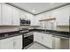 Well-equipped kitchen with granite countertops and stainless steel appliances, plus lots of storage at 12534 Chenwood Ave, Hudson, FL 34669